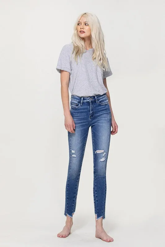 HIGH RISE ANKLE SKINNY WITH UNEVEN HEM DETAIL