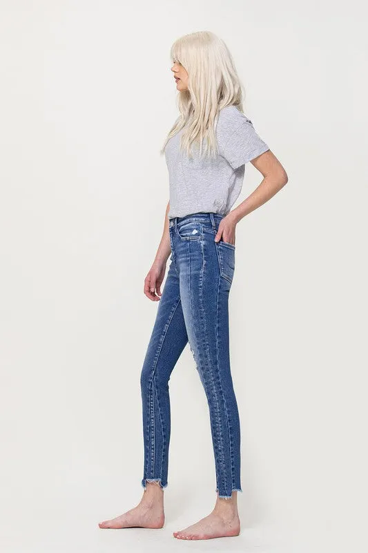 HIGH RISE ANKLE SKINNY WITH UNEVEN HEM DETAIL