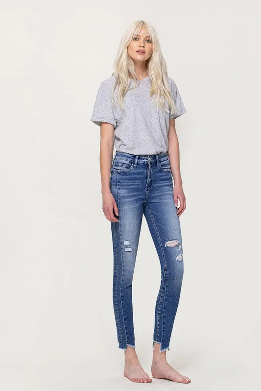 HIGH RISE ANKLE SKINNY WITH UNEVEN HEM DETAIL